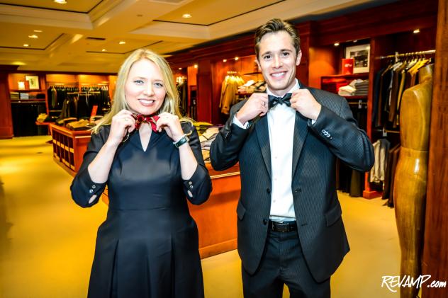 Brooks Brothers historian Kelly Nickel and ABC7 reporter Kris Van Cleave demonstrate proper bow tying technique.